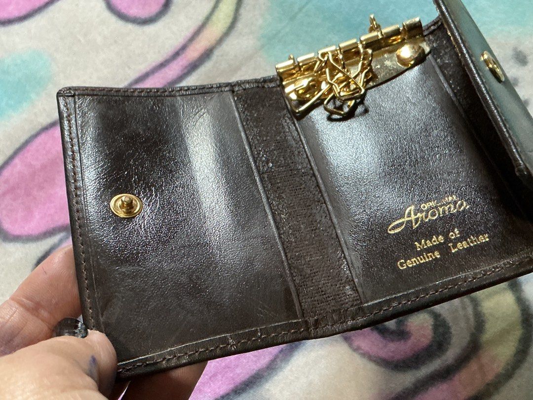 Aroma Genuine Leather Key Holder (Category: Wallets & Card holders) located in Angeles City. Submitted by goodbuysathome (Listing ID 1430265627, Image 3). Description: Aroma key holder is made of genuine leather. It features a key ring, a coin compartment, and a snap closure. The key holder is brown in color and has the Aroma logo on the front. It is a compact and stylish accessory for organizing your keys and small essentials. Add sf 55 gcash pa