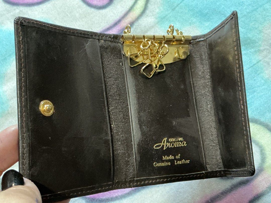 Aroma Genuine Leather Key Holder (Category: Wallets & Card holders) located in Angeles City. Submitted by goodbuysathome (Listing ID 1430265627, Image 2). Description: Aroma key holder is made of genuine leather. It features a key ring, a coin compartment, and a snap closure. The key holder is brown in color and has the Aroma logo on the front. It is a compact and stylish accessory for organizing your keys and small essentials. Add sf 55 gcash pa