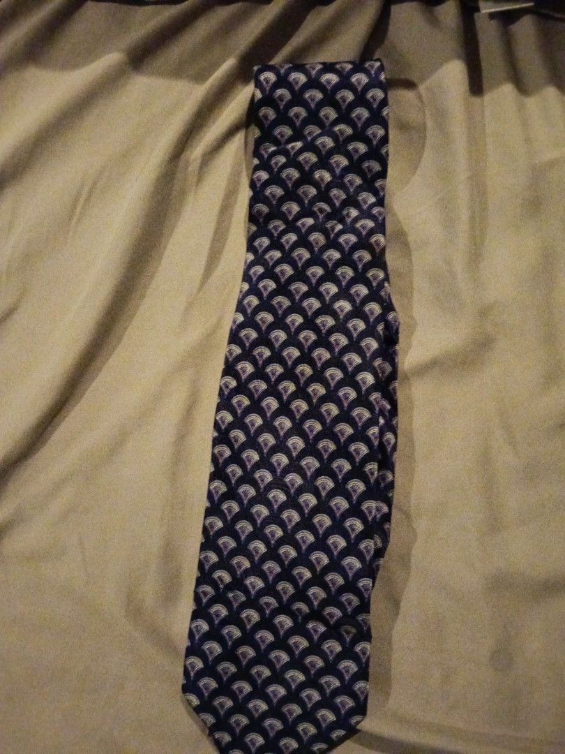 Assorted Patterned Ties (Category: Ties) located in Bukit Baharu. Submitted by kuhanmy (Listing ID 1430375655, Image 1). Description: Collection of assorted patterned ties. Includes ties with various designs such as a navy blue tie with a repeating pattern, a red tie, and a dark brown tie. The ties come in different colors and patterns, suitable for various occasions. Perfect for adding a touch of style to your outfit. *please note price is for e
