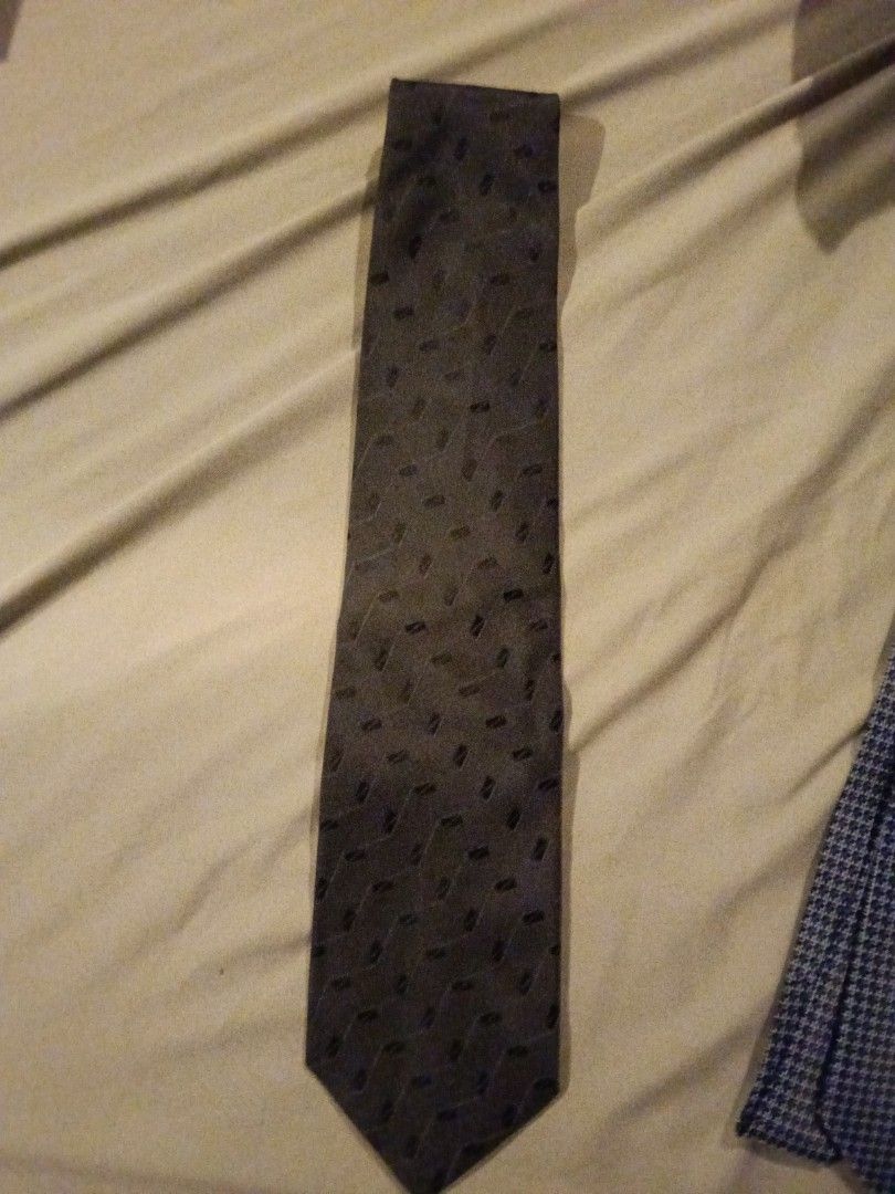 Assorted Patterned Ties (Category: Ties) located in Bukit Baharu. Submitted by kuhanmy (Listing ID 1430375655, Image 3). Description: Collection of assorted patterned ties. Includes ties with various designs such as a navy blue tie with a repeating pattern, a red tie, and a dark brown tie. The ties come in different colors and patterns, suitable for various occasions. Perfect for adding a touch of style to your outfit. *please note price is for e