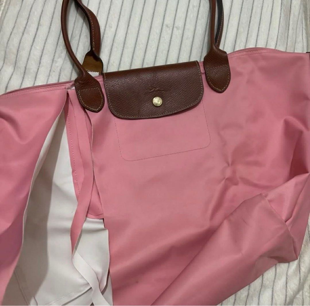 Authentic Longchamp Le Pliage Limited Edition Marshmallow (Needs Repair) (Category: Luxury Bags & Wallets) located in Alcala. Submitted by arie.thrift (Listing ID 1430224298, Image 1). Description: 🫐 selling my 100% original Large Longchamp Le Pliage tote in Marshmallow Pink. bought for around P10,000 before. still has the Made in France tag and the leather handles and flap are in good condition 🫐 there is a large tear on the nylon body and sid