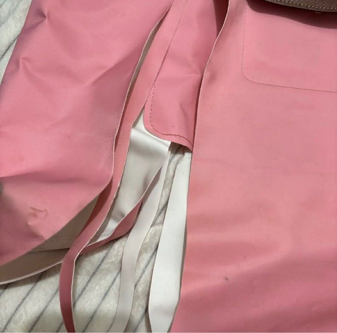 Authentic Longchamp Le Pliage Limited Edition Marshmallow (Needs Repair) (Category: Luxury Bags & Wallets) located in Alcala. Submitted by arie.thrift (Listing ID 1430224298, Image 2). Description: 🫐 selling my 100% original Large Longchamp Le Pliage tote in Marshmallow Pink. bought for around P10,000 before. still has the Made in France tag and the leather handles and flap are in good condition 🫐 there is a large tear on the nylon body and sid