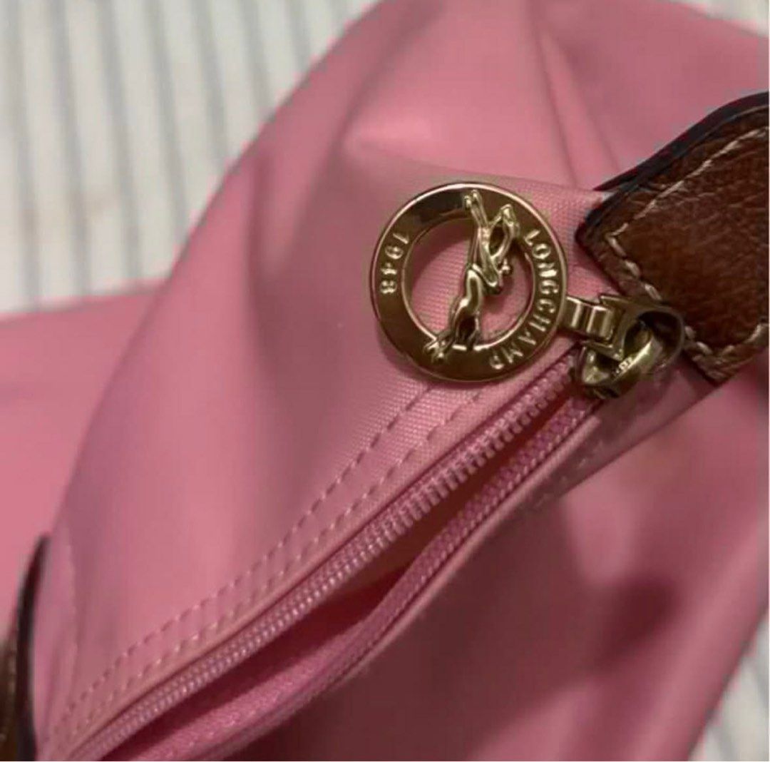 Authentic Longchamp Le Pliage Limited Edition Marshmallow (Needs Repair) (Category: Luxury Bags & Wallets) located in Alcala. Submitted by arie.thrift (Listing ID 1430224298, Image 3). Description: 🫐 selling my 100% original Large Longchamp Le Pliage tote in Marshmallow Pink. bought for around P10,000 before. still has the Made in France tag and the leather handles and flap are in good condition 🫐 there is a large tear on the nylon body and sid