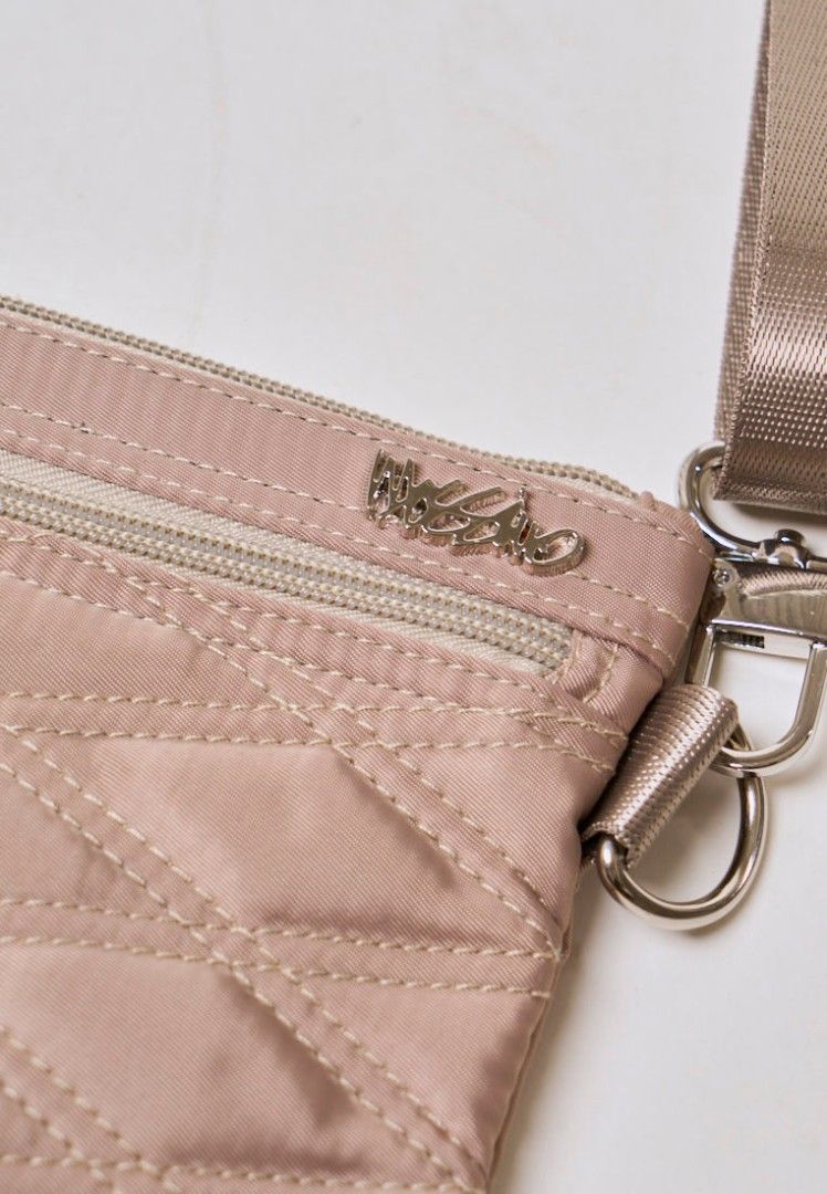 Authentic Mossimo Anika Beige Quilted Crossbody Bag (Category: Cross-body Bags) located in Davao. Submitted by jilly07 (Listing ID 1430399622, Image 2). Description: Stylish Mossimo crossbody bag in a neutral color. Features a quilted design and a zippered main compartment. Includes an adjustable strap for comfortable wear. Perfect for everyday use, offering both style and functionality. The bag has a silver-tone hardware and a small logo detail.
