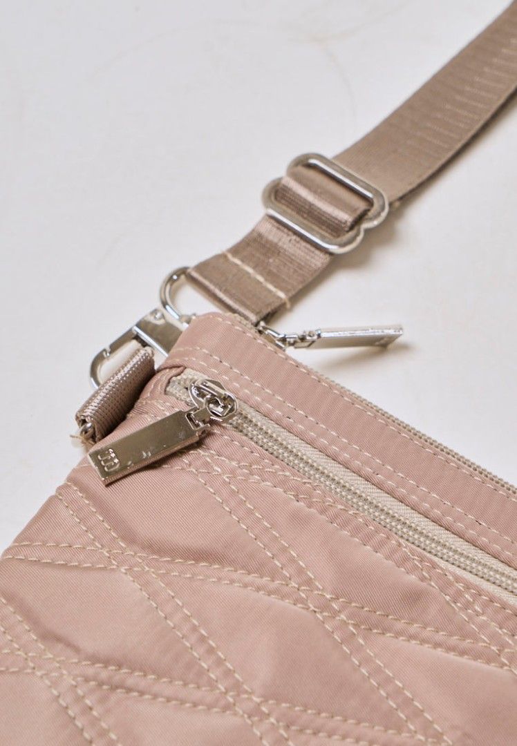 Authentic Mossimo Anika Beige Quilted Crossbody Bag (Category: Cross-body Bags) located in Davao. Submitted by jilly07 (Listing ID 1430399622, Image 3). Description: Stylish Mossimo crossbody bag in a neutral color. Features a quilted design and a zippered main compartment. Includes an adjustable strap for comfortable wear. Perfect for everyday use, offering both style and functionality. The bag has a silver-tone hardware and a small logo detail.