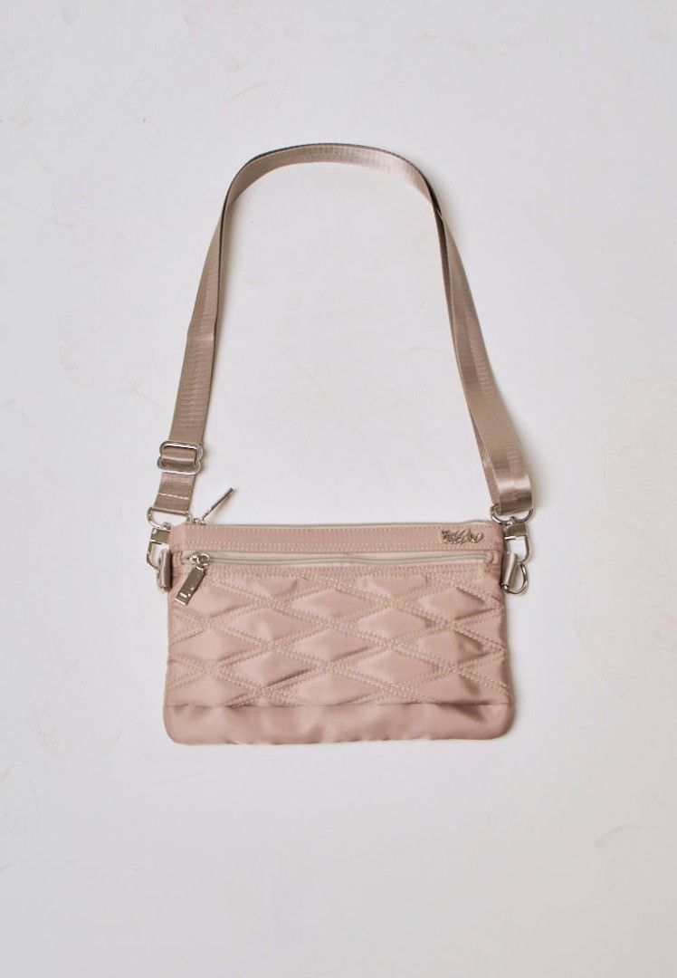 Authentic Mossimo Anika Beige Quilted Crossbody Bag (Category: Cross-body Bags) located in Davao. Submitted by jilly07 (Listing ID 1430399622, Image 1). Description: Stylish Mossimo crossbody bag in a neutral color. Features a quilted design and a zippered main compartment. Includes an adjustable strap for comfortable wear. Perfect for everyday use, offering both style and functionality. The bag has a silver-tone hardware and a small logo detail.