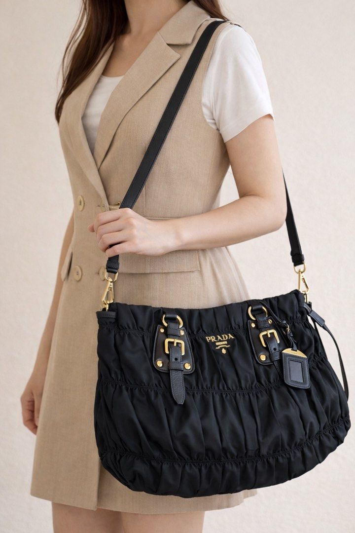 Authentic PR*DA Tessuto Gaufre (Category: Luxury Bags & Wallets) located in Pasig City. Submitted by luckybunch (Listing ID 1375912856, Image 1). Description: ✨ Prada Tessuto Gaufre Ruched Nylon Bag – Black ✨ Classic and timeless Prada piece from 2010 💼 Lightweight, spacious, and perfect for everyday use 🖤 Details: • Authentic Prada Tessuto Gaufre nylon • Color: Nero (black) with gold hardware • Comes with original card + dust bag • With detach