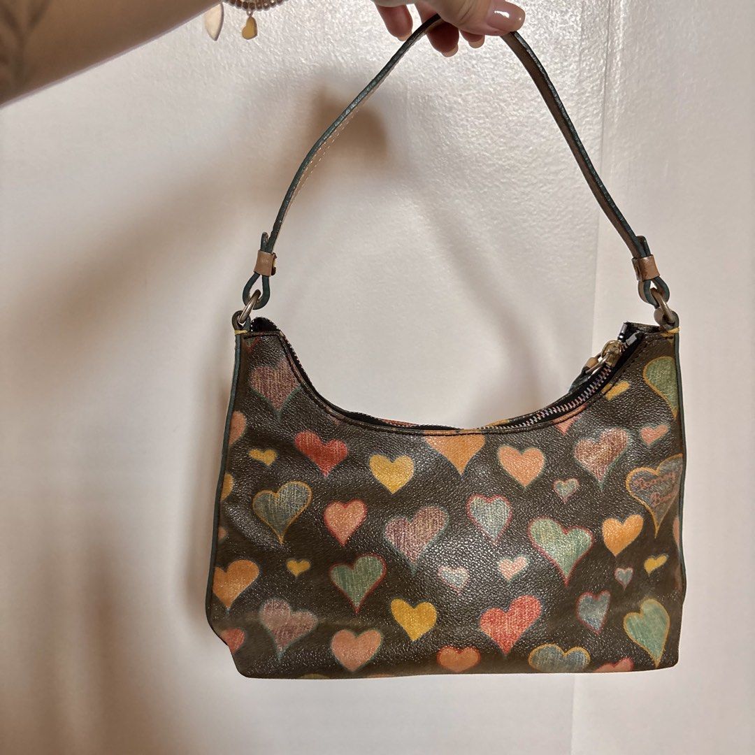 Authentic Vintage Dooney & Bourke Shoulder Bag (Category: Luxury Bags & Wallets) located in Quezon City. Submitted by vaultedlovecloset (Listing ID 1430290410, Image 2). Description: No when worn photos. All actual photos posted. Patina tanned leather strap and sides. The inner keychain attached to the inner lining is broken but the bag is still useable. No damages on the outer bag ✨AUTO-REMINDER✨ 🤎DETAILS mentioned in the description box 📍Loca