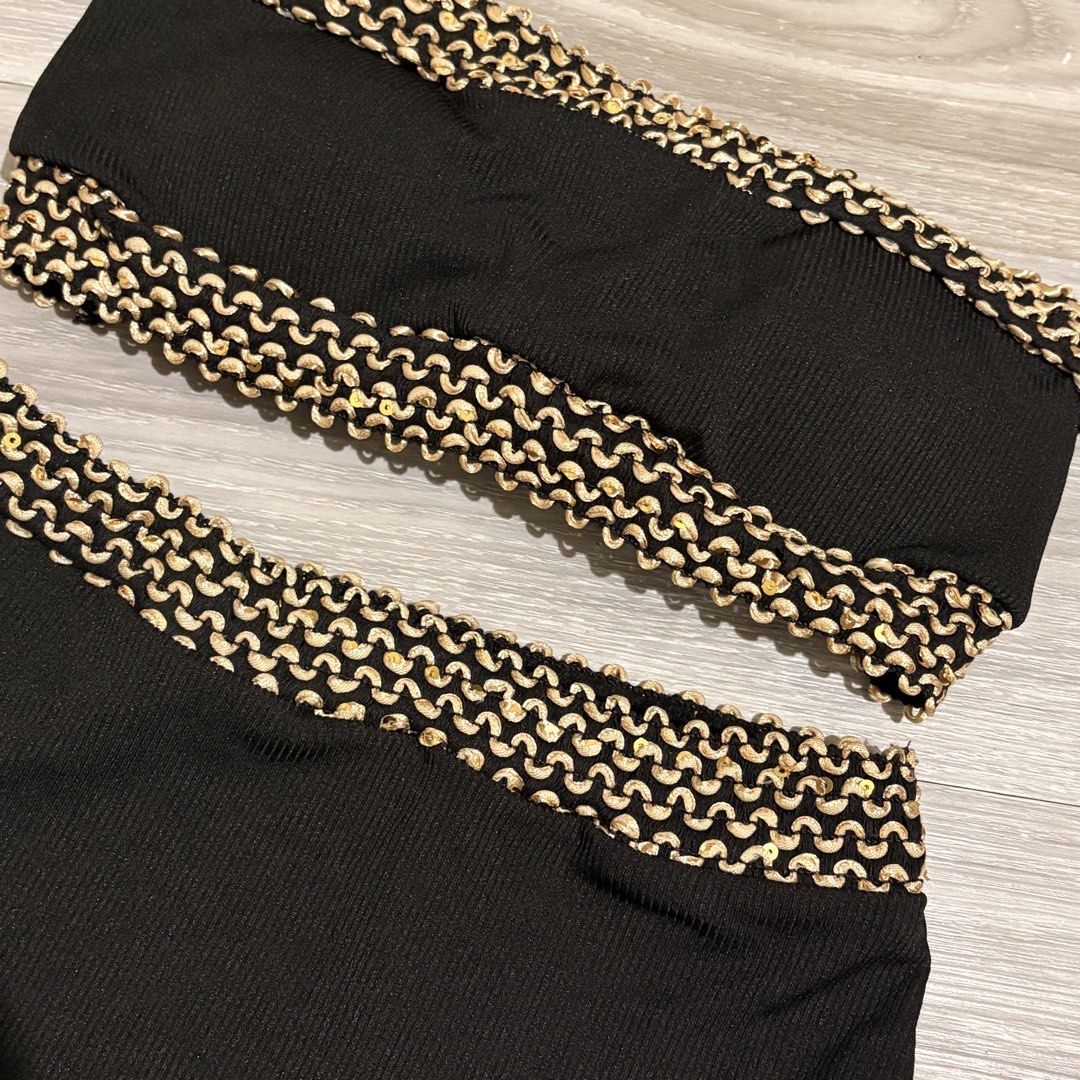 Black Bikini Set with Gold Detailing - Size S (Category: Bikinis & Swimsuits) located in Tarlac. Submitted by shantirisque (Listing ID 1430257935, Image 2). Description: Black bikini set with pads features a bandeau top and high-waisted bottoms. The edges of both pieces are adorned with a gold, textured trim. The set is a size small, as indicated on the label. This two-piece swimsuit is perfect for the beach or pool..