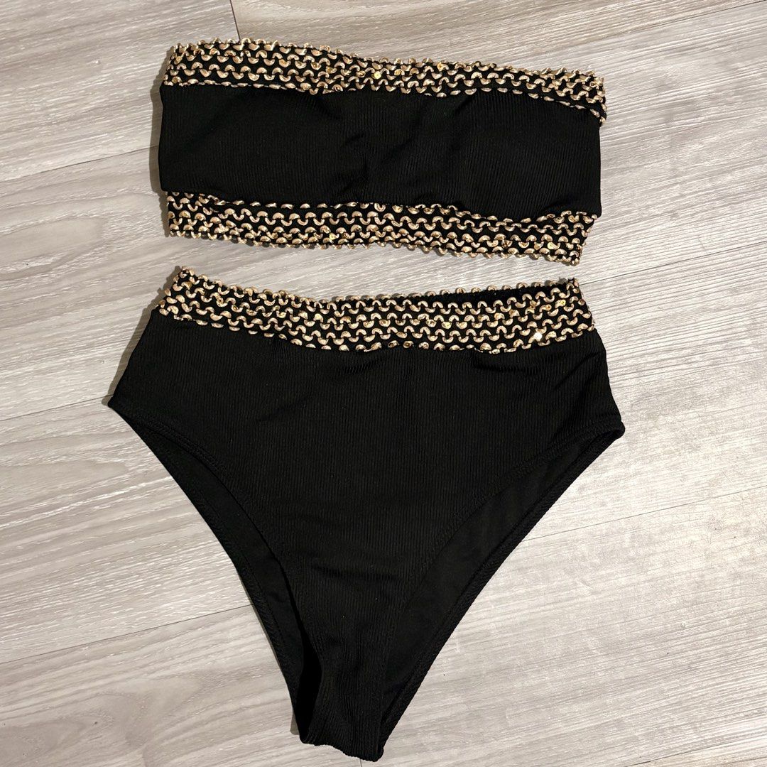 Black Bikini Set with Gold Detailing - Size S (Category: Bikinis & Swimsuits) located in Tarlac. Submitted by shantirisque (Listing ID 1430257935, Image 1). Description: Black bikini set with pads features a bandeau top and high-waisted bottoms. The edges of both pieces are adorned with a gold, textured trim. The set is a size small, as indicated on the label. This two-piece swimsuit is perfect for the beach or pool..