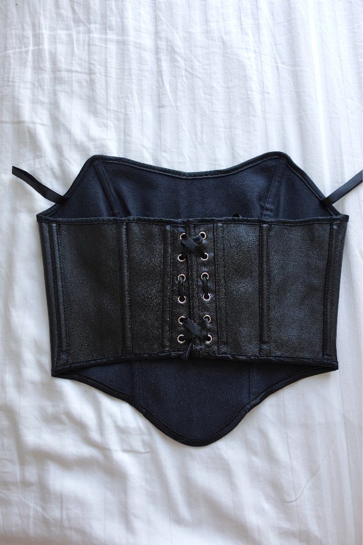 Black Faux Leather Corset (Category: Others Tops) located in Taguig. Submitted by adanimottoshop (Listing ID 1430381224, Image 2). Description: Black faux leather corset with a lace-up back. Features a structured design with multiple panels and stitching details. Includes straps for secure wear..