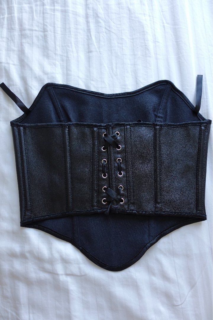 Black Faux Leather Corset (Category: Others Tops) located in Taguig. Submitted by adanimottoshop (Listing ID 1430381224, Image 3). Description: Black faux leather corset with a lace-up back. Features a structured design with multiple panels and stitching details. Includes straps for secure wear..