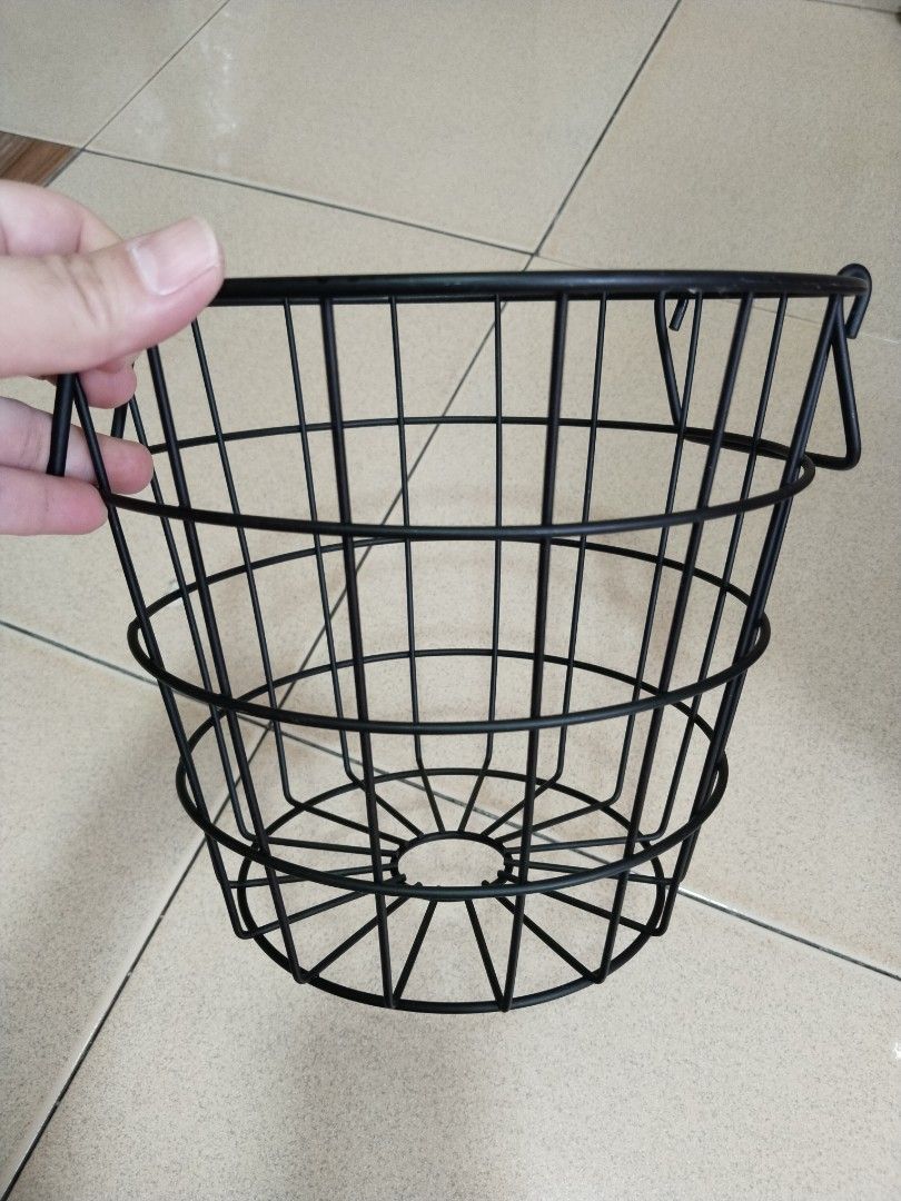 Black Metal Wire Basket (Category: Storage Boxes & Baskets) located in Manila. Submitted by ashenclyde0606 (Listing ID 1430244381, Image 2). Description: - Black metal wire basket - Sturdy construction - Circular base with flared top - Features handles for easy carrying - Open design for ventilation and visibility - Ideal for organizing items.