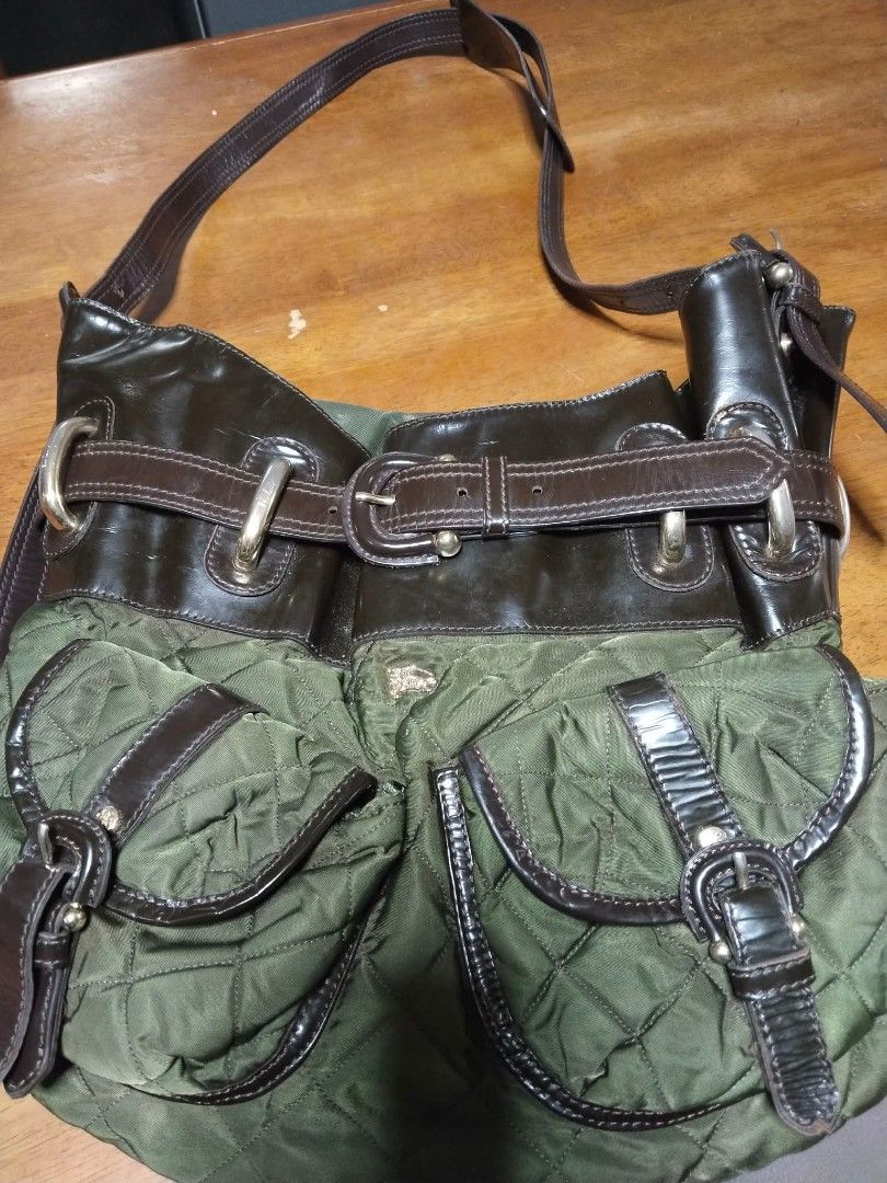 Burberry Shoulder Bag (Category: Luxury Bags & Wallets) located in Caloocan City. Submitted by bravedolphin-5f20 (Listing ID 1430314458, Image 3). Description: Stylish Burberry shoulder bag featuring a unique design with quilted green fabric and brown leather accents. It has multiple pockets and a secure buckle closure. The bag includes a long shoulder strap for comfortable carrying. The interior features a Burberry label. A classic and functiona