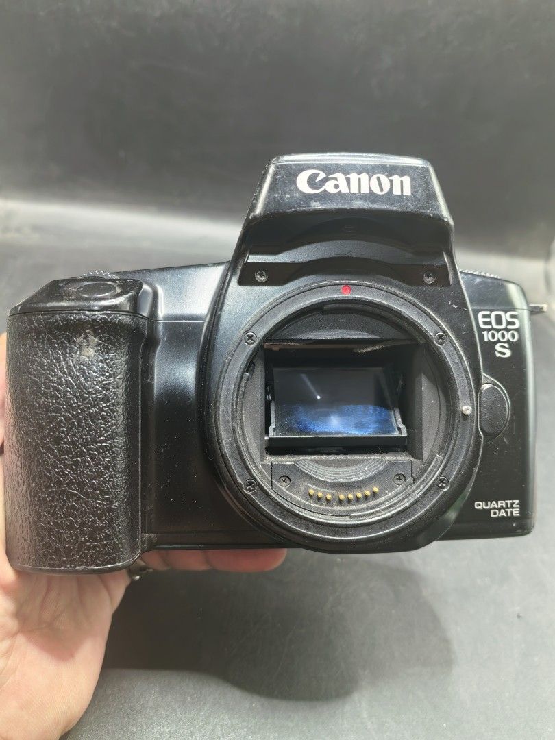 Canon EOS 1000S film Camera - Body Only (Category: Cameras) located in Cebu City. Submitted by dudes_villanueva (Listing ID 1430218923, Image 1). Description: Canon EOS 1000S (also known as the EOS Rebel SII in the Americas) - Body Only Note: Tested Functional. All sales final and non-refundable. Battery not included for testing and demo only. Condition: Working Mirror Flip and Dial Settings. Clean battery compartment. Has body scratches. Sold as