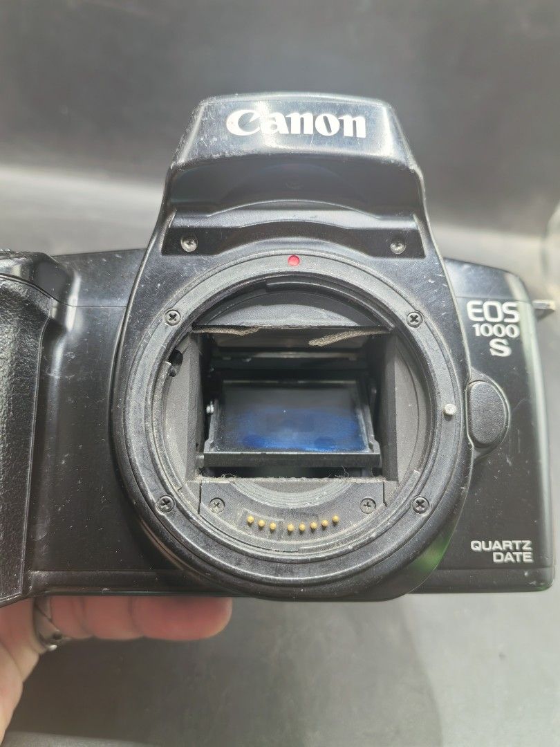 Canon EOS 1000S film Camera - Body Only (Category: Cameras) located in Cebu City. Submitted by dudes_villanueva (Listing ID 1430218923, Image 2). Description: Canon EOS 1000S (also known as the EOS Rebel SII in the Americas) - Body Only Note: Tested Functional. All sales final and non-refundable. Battery not included for testing and demo only. Condition: Working Mirror Flip and Dial Settings. Clean battery compartment. Has body scratches. Sold as