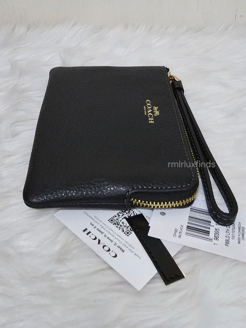 Coach Corner SIngle Zip Black Pebbled Leather Wristlet🇺🇲Authentic (Category: Luxury Bags & Wallets) located in Quezon City. Submitted by rmlrluxfinds (Listing ID 1413866484, Image 2). Description: ** brandnew, sealed and authentic ** measures 6.25"L x 4"H x 0.5"W ** refined pebble leather ** fabric lining ** wrist strap attached ** 2 credit card slots ** zip-top closure ON HAND and ready to ahip ✅️tag ✅️carecard rmlrluxfinds is not associated o