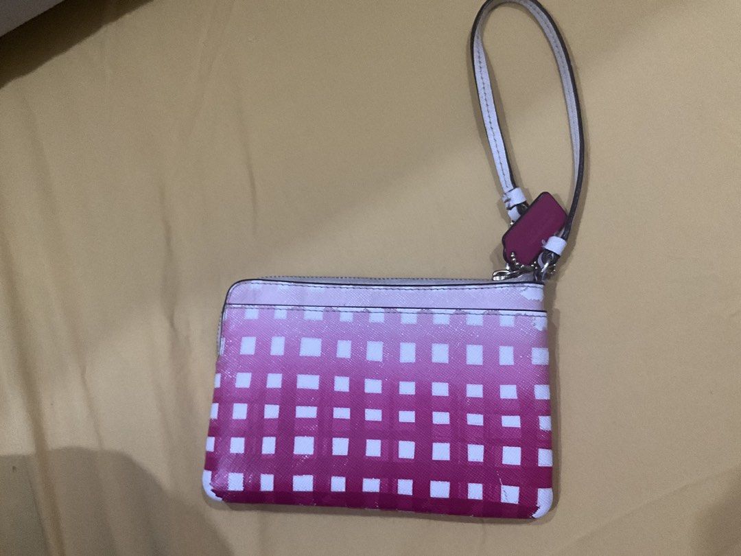 Coach Wristlet with Pink Gradient Design (Category: Wallets & Card holders) located in Las Pinas. Submitted by pachdeclutters (Listing ID 1430310755, Image 2). Description: Coach wristlet with a pink gradient square pattern. - Guaranteed Authentic (bought in US) - Features a wrist strap and a zip closure. - Includes the original Coach box. - The wristlet has some wear and tear on the edges. *Please manage your expectations as this is preloved.
