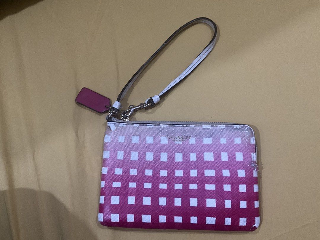 Coach Wristlet with Pink Gradient Design (Category: Wallets & Card holders) located in Las Pinas. Submitted by pachdeclutters (Listing ID 1430310755, Image 1). Description: Coach wristlet with a pink gradient square pattern. - Guaranteed Authentic (bought in US) - Features a wrist strap and a zip closure. - Includes the original Coach box. - The wristlet has some wear and tear on the edges. *Please manage your expectations as this is preloved.