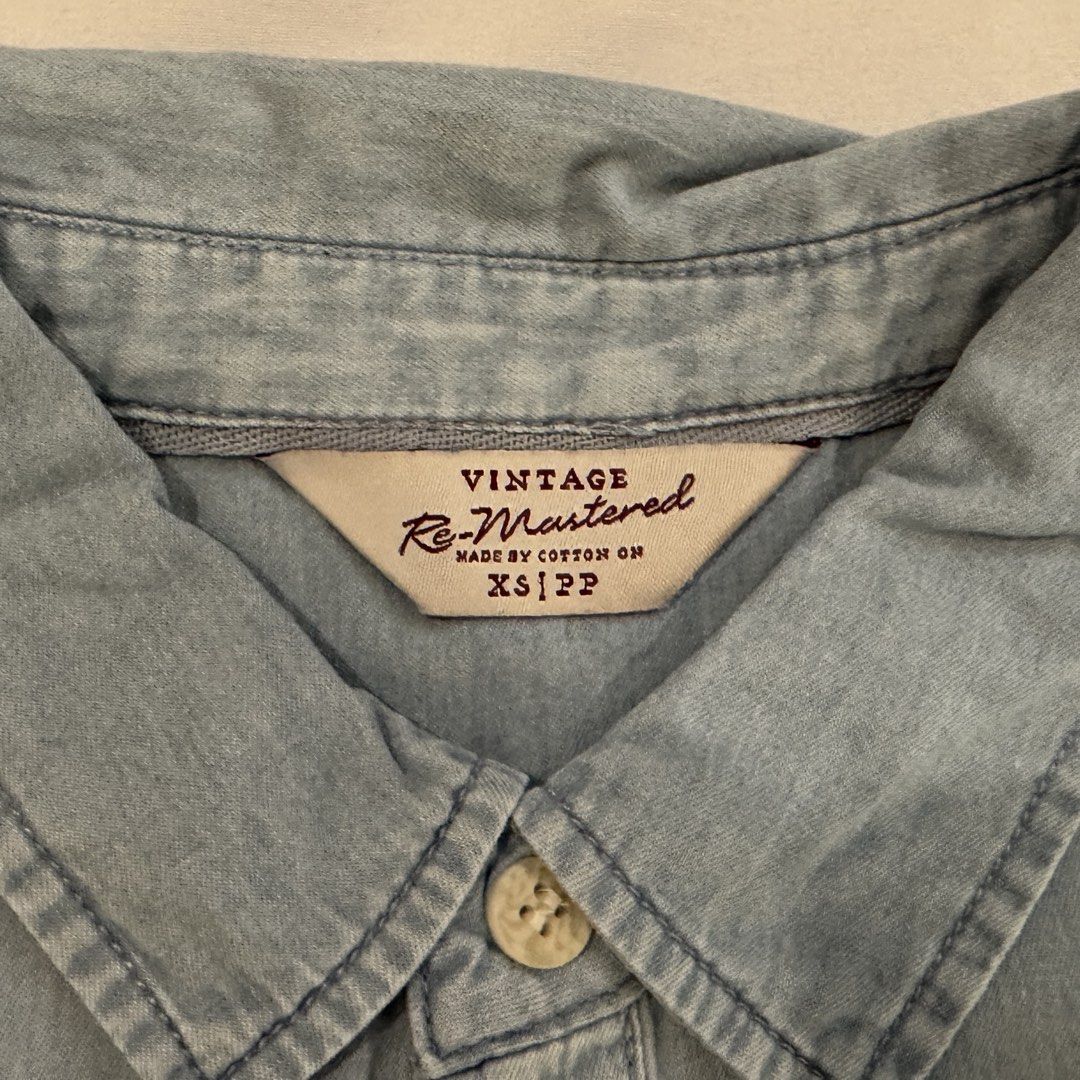 Cotton On Light Blue Shirt - XS (Category: Tshirts & Polo Shirts ) located in Paranaque City. Submitted by anmangle (Listing ID 1430219351, Image 3). Description: Size: XS * W: 19” * L: 26” Color: Light Blue Pre-loved Issue: Old RFS: decluttering Shipping only 🛵 PM for more details 📩 [Carousell-generated description] • Light blue denim shirt from Vintage Re-Mastered. • Features a button-down front, short sleeves, and a single chest pocket. • Th