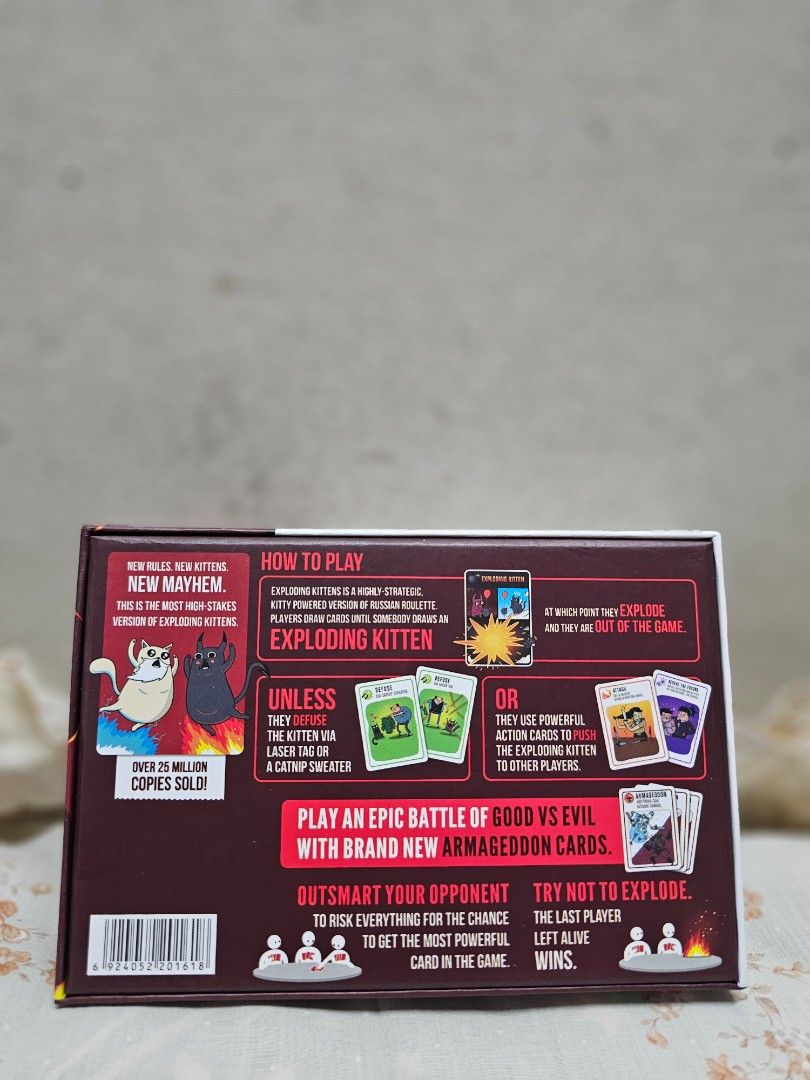 Exploding Kittens: Good vs Evil Card Game (Category: Board Games & Puzzles) located in Manila. Submitted by shopwithella.ph (Listing ID 1430304716, Image 2). Description: Exploding Kittens: Good vs Evil card game. Includes 93 cards, 1 rule book, and 1 Good vs Evil playmat. For 2-5 players. Features new cards and gameplay. Outsmart your opponent with brand new Armageddon cards. The last player left alive wins the game..