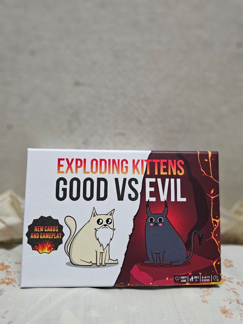 Exploding Kittens: Good vs Evil Card Game (Category: Board Games & Puzzles) located in Manila. Submitted by shopwithella.ph (Listing ID 1430304716, Image 1). Description: Exploding Kittens: Good vs Evil card game. Includes 93 cards, 1 rule book, and 1 Good vs Evil playmat. For 2-5 players. Features new cards and gameplay. Outsmart your opponent with brand new Armageddon cards. The last player left alive wins the game..