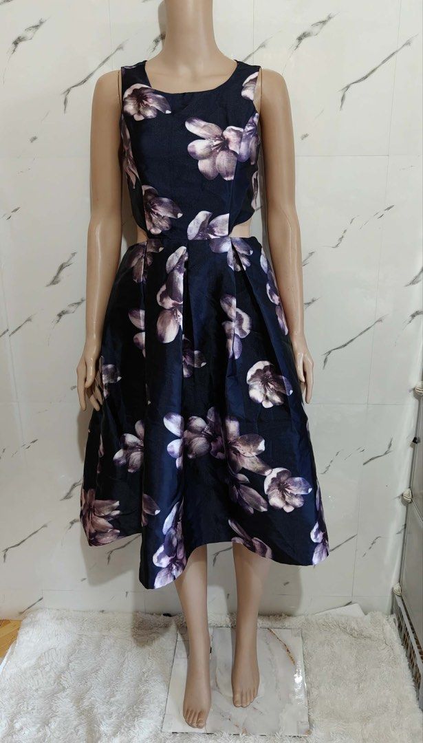 Floral Cut-out Dress (Category: Dresses) located in Cebu City. Submitted by vedazzle (Listing ID 1430252799, Image 2). Description: 📍Elegant dress featuring a navy blue background with large floral patterns. 📍It has a cutout design at the waist and a zipper closure at the back. 📍The dress has a sleeveless design and a pleated skirt. Perfect for special occasions..