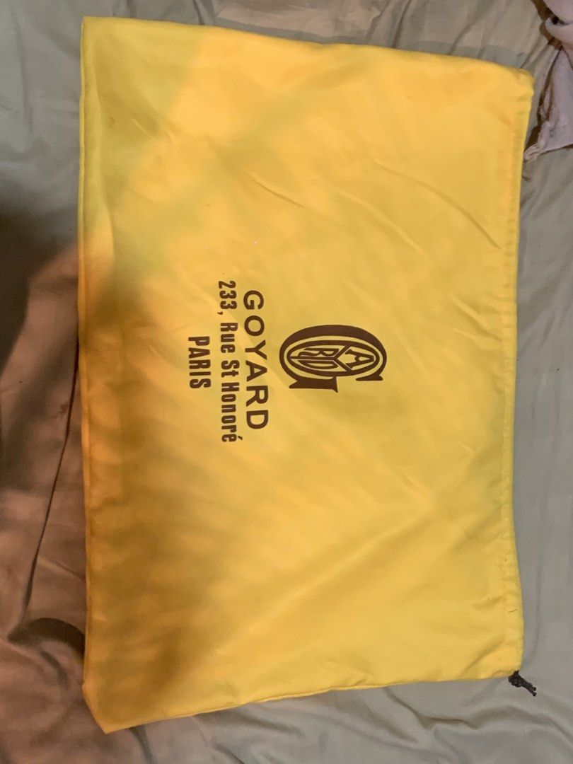 Goyard Dust Bag (Category: Luxury Bags & Wallets) located in Manila. Submitted by moneymann888 (Listing ID 1430367384, Image 2). Description: Sf Buyer shoulder Goyard dust bag. Features the Goyard logo and address on the front. The bag is yellow and has a drawstring closure. The bag is designed to protect luxury items. size Witdth 18inches and height 13 inches .