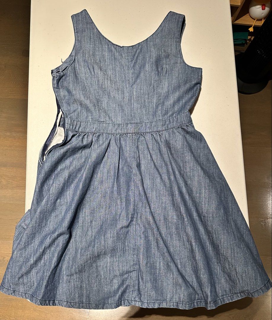 Iora Denim Dress - Size M (Category: Dresses) located in Pasig City. Submitted by repurposed.2021 (Listing ID 1430360357, Image 2). Description: Denim dress from Iora features a button-down front design (but zipper on the side) and two front pockets. It has a fitted bodice and a flared skirt. The size tag indicates a size M..