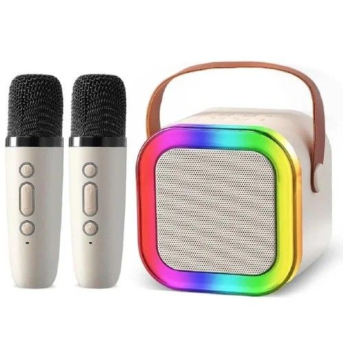 K12 Karaoke Speaker with 2 Microphones (Category: Soundbars, Speakers & Amplifiers) located in Paranaque City. Submitted by powerzone0517 (Listing ID 1430398457, Image 2). Description: K12 karaoke speaker set comes with two microphones and a colorful LED light display. It includes a speaker unit with a handle, two microphones, a charging cable, and a user manual. The speaker has a built-in grill and control buttons. Available in multiple colors, 
