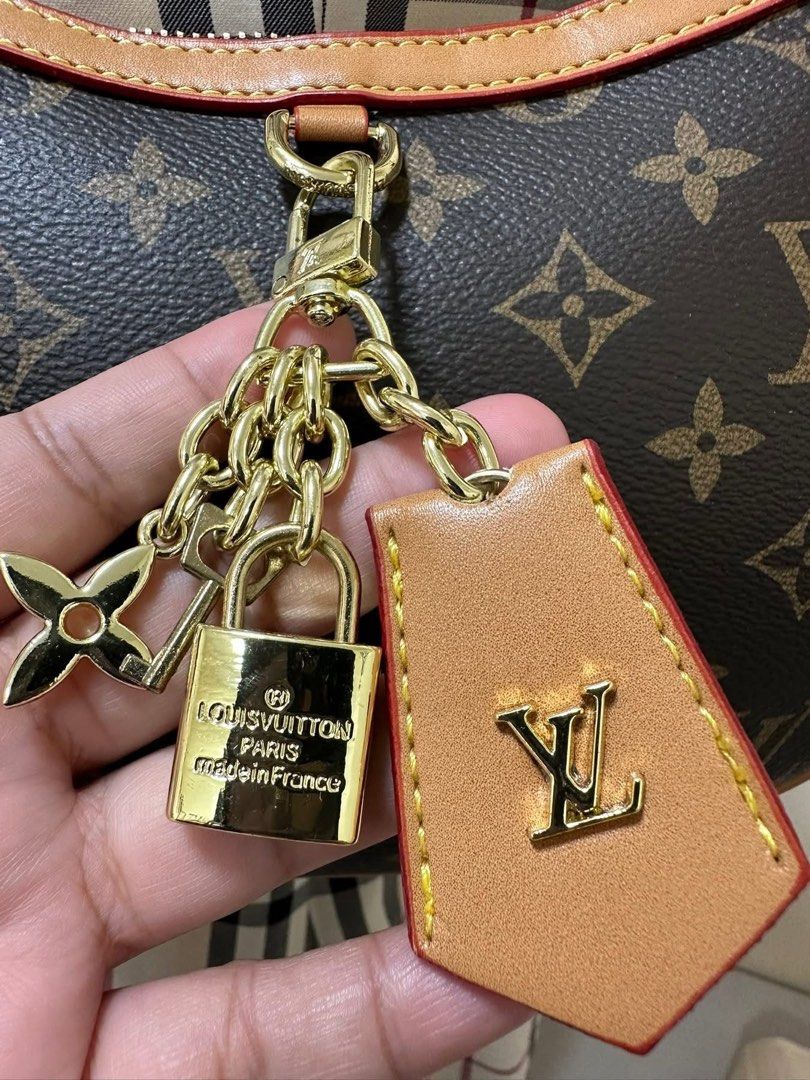LV Croissant PM Handbag (Category: Luxury Bags & Wallets) located in Los Banos. Submitted by ditasbautista2329 (Listing ID 1430291979, Image 3). Description: Louis Vuitton Croissant PM handbag in brown monogram .Features a crescent shape with a red leather trim and a top zipper closure. Includes a gold-tone chain with a padlock charm and a leather tag. The interior is lined with a burgundy fabric and has a small pocket. Includes a serial number i