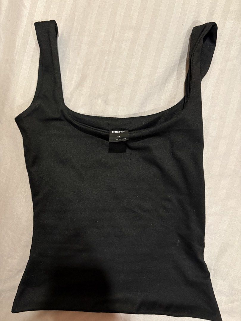 Mera Black Arya Tank Top (Category: Sleeveless) located in Quezon City. Submitted by perry.declutters (Listing ID 1430264174, Image 1). Description: - Mera black tank top - Square neckline - Thick straps - Smooth fabric - Versatile basic.