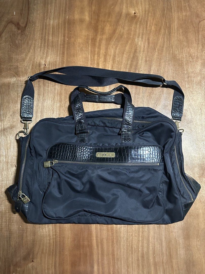 Moschino Travel Bag (Category: Luxury Bags & Wallets) located in Bacolod City. Submitted by dannnsoy (Listing ID 1430335480, Image 1). Description: Moschino Travel Bag •In very good condition •Issue: Missing keys and signs of usage •Price: 1999 only 📍Note: Color may vary to due lighting and camera resolution. .