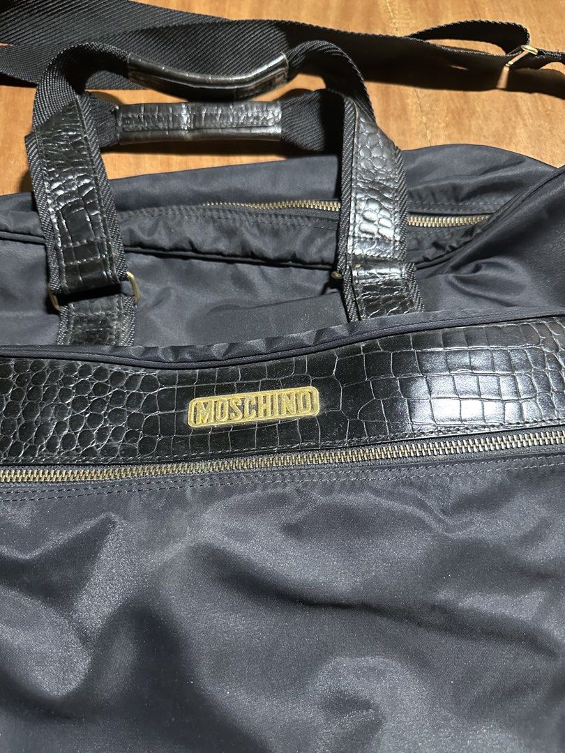 Moschino Travel Bag (Category: Luxury Bags & Wallets) located in Bacolod City. Submitted by dannnsoy (Listing ID 1430335480, Image 2). Description: Moschino Travel Bag •In very good condition •Issue: Missing keys and signs of usage •Price: 1999 only 📍Note: Color may vary to due lighting and camera resolution. .
