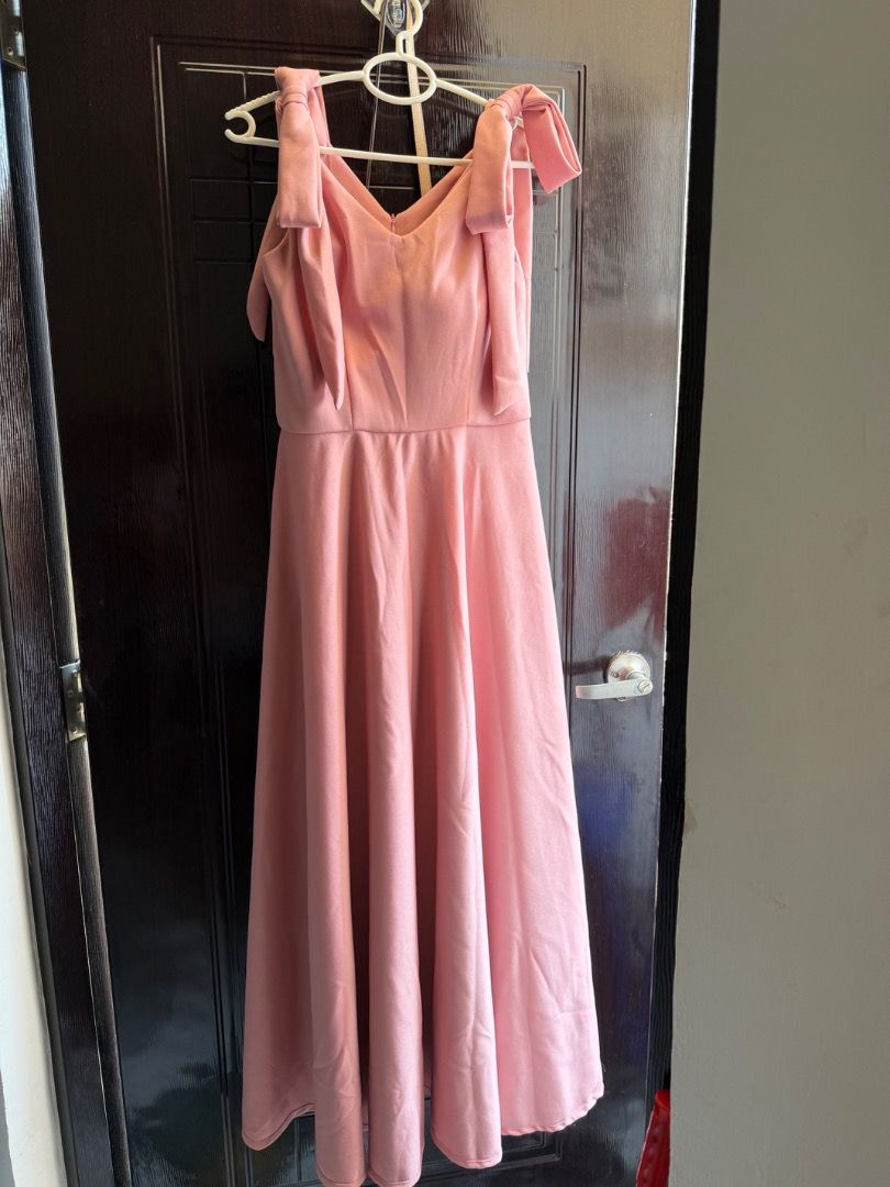 Pink Bow Shoulder Dress (Category: Dresses) located in Pasig City. Submitted by alwaysfaevored (Listing ID 1430272187, Image 3). Description: Elegant pink dress featuring bow shoulder straps and a V-neckline. The dress has a fitted bodice that flows into a flared skirt. Perfect for special occasions or formal events. Used once, at a friend’s wedding..