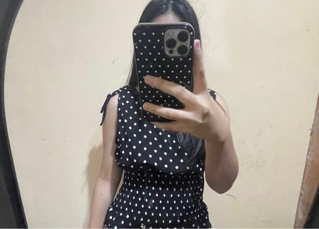 Polka Dot Sleeveless Top (Category: Sleeveless) located in Bacolod City. Submitted by girlydecluttering (Listing ID 1430290131, Image 1). Description: Black sleeveless top with white polka dots. Features tie details on the shoulders and a shirred waist. The style is casual and suitable for everyday wear..