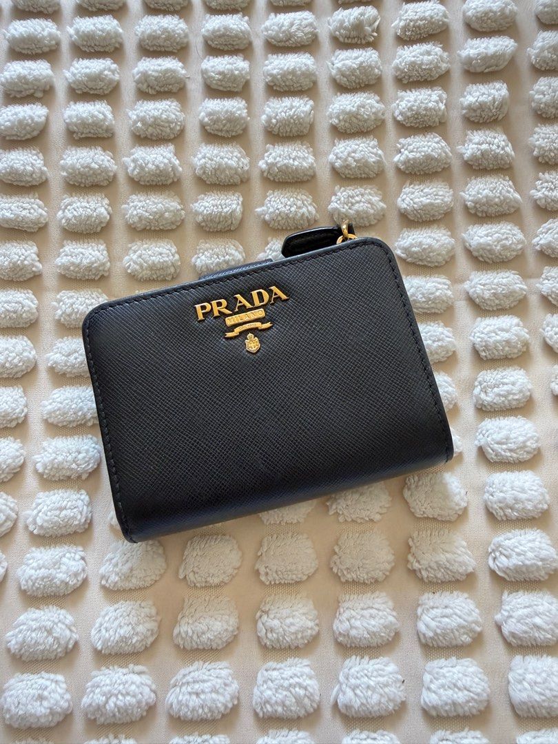 Rare Prada Saffiano Compact Wallet with Zipper (Category: Luxury Bags & Wallets) located in Del Monte. Submitted by mmbsundaybaby (Listing ID 1430248898, Image 2). Description: Bought from @sonuvintageph Rare design Used only 1-2x Super nice saffiano leather No rubs on the corners Super slight fading on the Prada logo hardware (common for prada wallets) .
