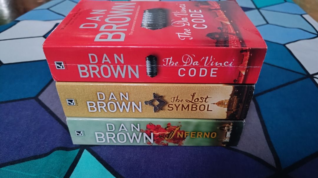 Robert Langdon Book Set (The Da Vinci Code, The Lost Symbol, Inferno) [DAN BROWN] (Category: Storybooks) located in Nagcarlan. Submitted by cristianityy (Listing ID 1430264231, Image 2). Description: Robert Langdon Book Set by Dan Brown * The Da Vinci Code * The Lost Symbol * Inferno - Format: MMPB (4.25" x 7") - Purchase Details: NBS - Condition: Looks as good as new, read only once, no tanning pages, only issue is The Da Vinci Code has cracked 