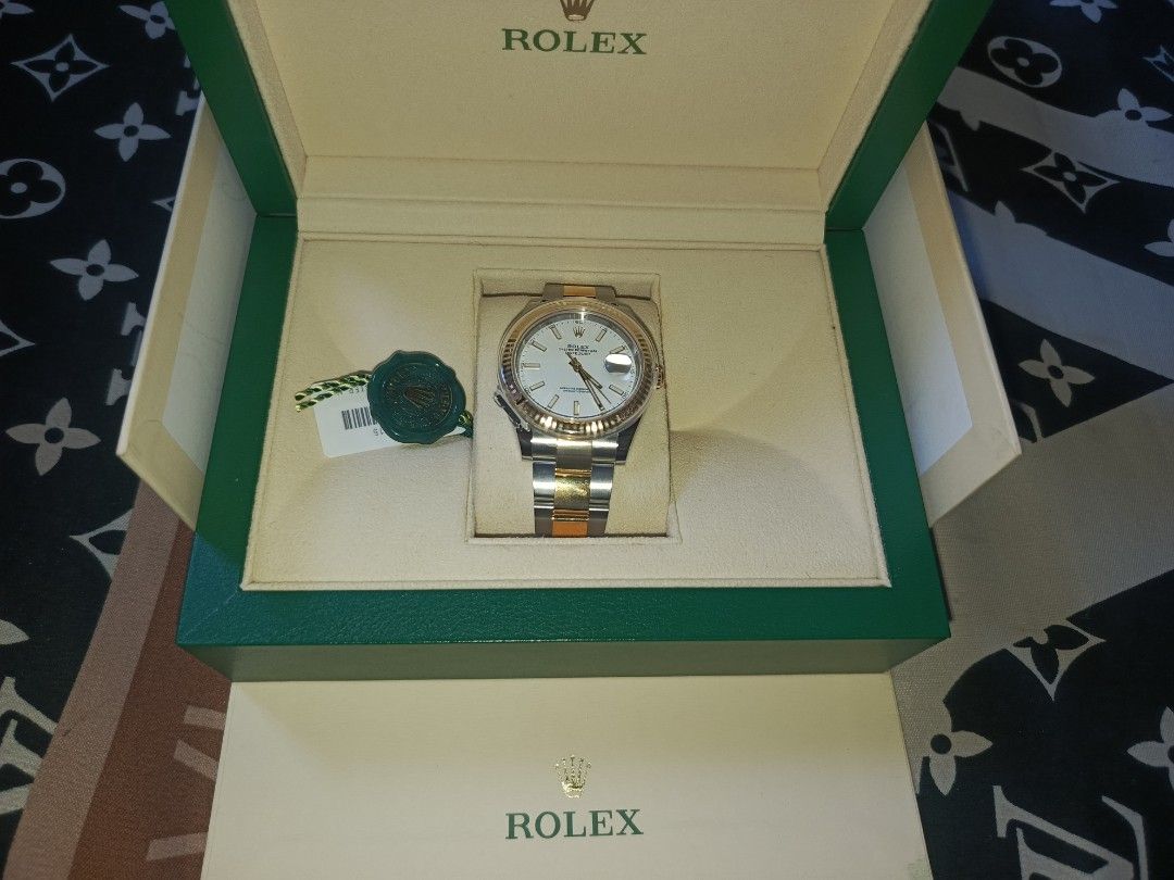 Rolex Datejust Watch (Category: Luxury Watches) located in Dagupan City. Submitted by golden12344 (Listing ID 1430253765, Image 1). Description: Rolex Datejust watch with a silver dial and gold and silver bracelet. Includes the original box, warranty card, and booklets. The watch is a classic design, perfect for everyday wear or special occasions..