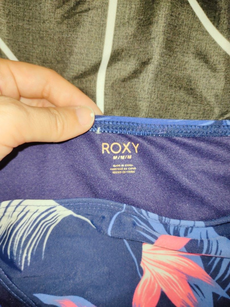 Roxy Bikini and unbranded - Size M (Category: Bikinis & Swimsuits) located in Manila. Submitted by thatstyle (Listing ID 1430308986, Image 3). Description: Roxy bikini set featuring a patterned top and a solid black bottom. The top has a halter neck design. The bottom is a classic cut. Both pieces are size M. The set is made of a comfortable material, perfect for beach or pool days..