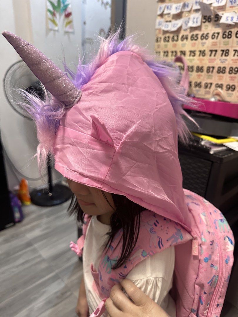 Smiggle Unicorn Backpack (Category: Babies & Kids Fashion) located in Valenzuela. Submitted by mommyiish (Listing ID 1430268214, Image 2). Description: - Smiggle Unicorn Backpack - Fun unicorn design - Pink exterior with unicorn graphics - Large unicorn-shaped pocket - Includes matching unicorn hood - Pink interior with Smiggle logo - Adjustable straps - Top handle.