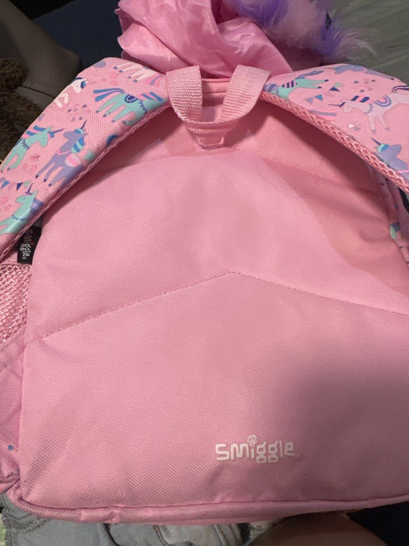 Smiggle Unicorn Backpack (Category: Babies & Kids Fashion) located in Valenzuela. Submitted by mommyiish (Listing ID 1430268214, Image 3). Description: - Smiggle Unicorn Backpack - Fun unicorn design - Pink exterior with unicorn graphics - Large unicorn-shaped pocket - Includes matching unicorn hood - Pink interior with Smiggle logo - Adjustable straps - Top handle.