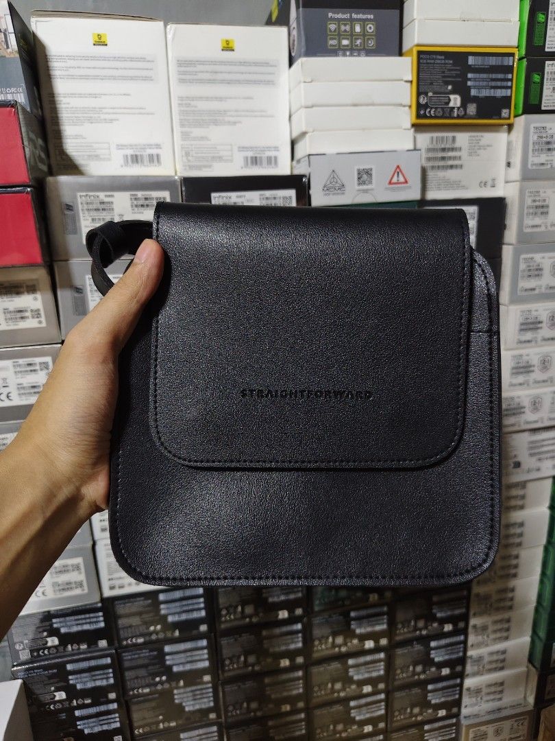 Straightforward Black Crossbody Bag (Category: Cross-body Bags) located in Marilao. Submitted by declutterwjosh13 (Listing ID 1430352017, Image 1). Description: Black crossbody bag from Straightforward. Features a flap closure with magnetic snaps. Includes an adjustable shoulder strap. The bag has a main compartment and a small pocket inside. The exterior is smooth, and the brand name is subtly embossed on the front..