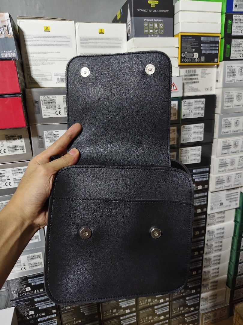 Straightforward Black Crossbody Bag (Category: Cross-body Bags) located in Marilao. Submitted by declutterwjosh13 (Listing ID 1430352017, Image 2). Description: Black crossbody bag from Straightforward. Features a flap closure with magnetic snaps. Includes an adjustable shoulder strap. The bag has a main compartment and a small pocket inside. The exterior is smooth, and the brand name is subtly embossed on the front..