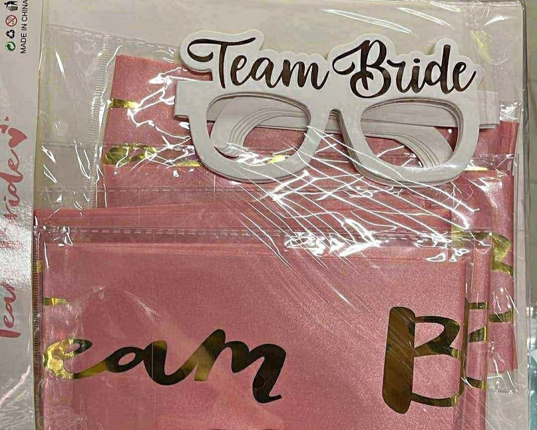 Team Bride Party Supplies (Category: Occasions & Party Supplies) located in Manila. Submitted by ohitsmezsa (Listing ID 1430260787, Image 1). Description: - Set includes a "Team Bride" sash and a pair of "Team Bride" glasses. - The sash is pink with gold lettering. - The glasses are white with the words "Team Bride" on them. - Perfect for a bachelorette party or bridal shower..