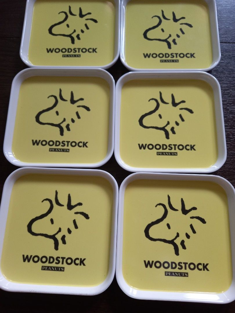 Woodstock Peanuts Trays Set (Category: Other Kitchenware & Tableware) located in Quezon City. Submitted by charsonetrends (Listing ID 1430224362, Image 2). Description: Set of six square trays featuring Woodstock from Peanuts. Each tray has a yellow interior with the Woodstock design and the word "Woodstock" printed on it. The trays have white borders and backs. The copyright information "© 2021 Peanuts Worldwide LLC" is visible on the back of th