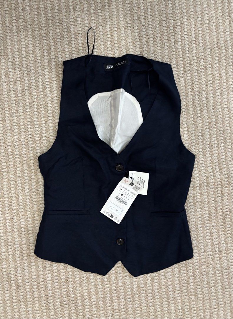 Zara Navy Vest - Size S (Category: Others Tops) located in Urdaneta. Submitted by zrayray (Listing ID 1430396909, Image 3). Description: Zara navy vest with a V-neck design. It features two buttons and two front pockets. The vest is size S. The tag is still attached..