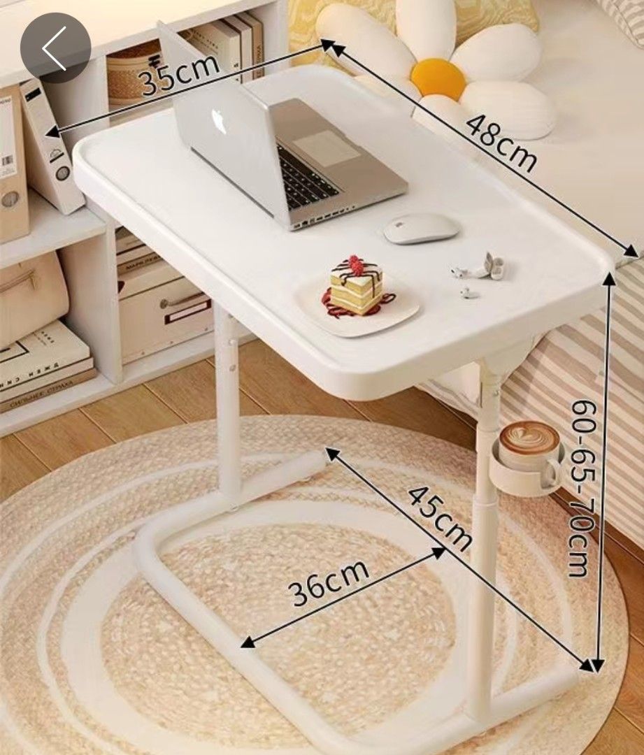 Adjustable Study Table （分類：桌子）位於 Hong Kong。 由 venkat24_a 提交（商品編號 1430452795，圖片 1）。簡介： Adjustable Study /TV/ laptop / etc., tray table is perfect for working, eating, or relaxing. It features a white tabletop with dimensions of 48cm x 35cm. The height is adjustable from 60cm to 70cm. It includes a cup holder and is designed for convenience.。