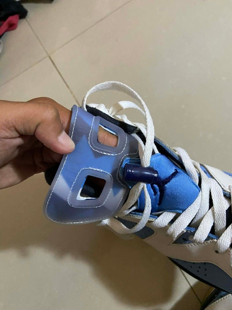 Air Jordan 6 Retro UNC (Category: Sneakers) located in Caloocan City. Submitted by y2kgearrr (Listing ID 1430237202, Image 2). Description: Air Jordan 6 Retro in a white, blue, and black colorway. Features a white leather upper with blue accents on the tongue, toe, and midsole. The midsole also has a yellowed tint. The shoe has a black outsole and a visible Air unit in the heel. Includes white laces..