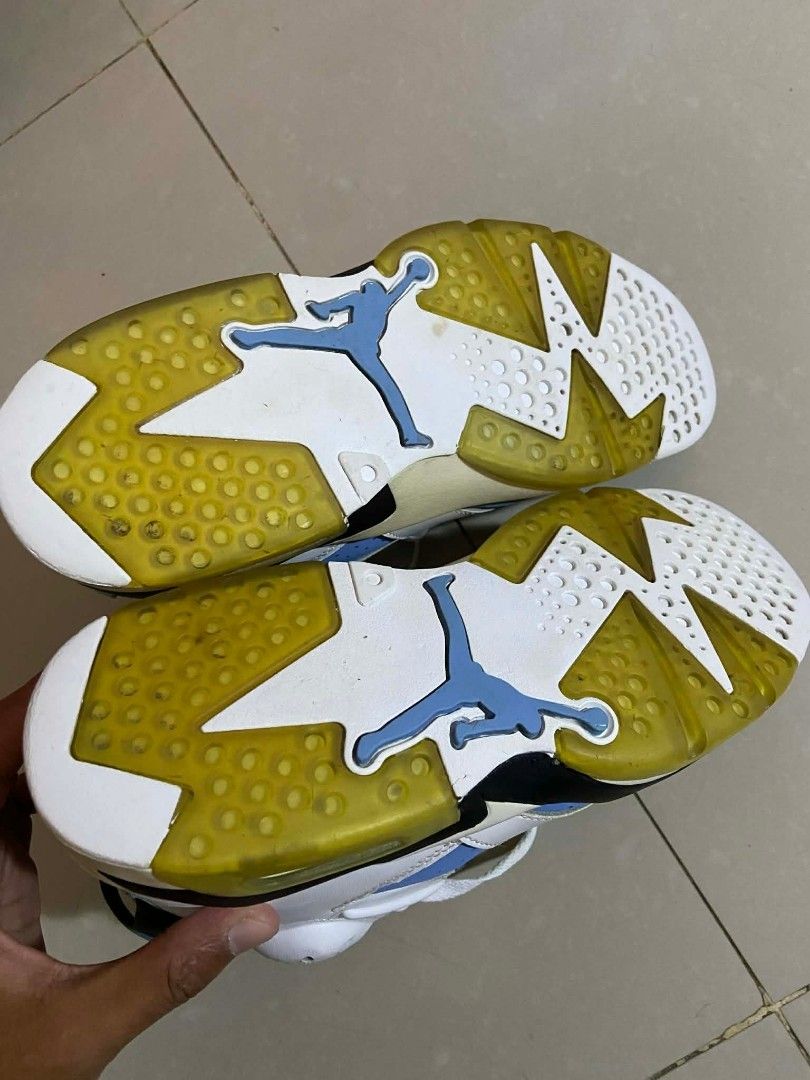 Air Jordan 6 Retro UNC (Category: Sneakers) located in Caloocan City. Submitted by y2kgearrr (Listing ID 1430237202, Image 3). Description: Air Jordan 6 Retro in a white, blue, and black colorway. Features a white leather upper with blue accents on the tongue, toe, and midsole. The midsole also has a yellowed tint. The shoe has a black outsole and a visible Air unit in the heel. Includes white laces..